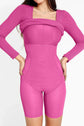 Woman wearing a pink bodycon dress with long sleeves, showcasing a sleek and stylish design.
