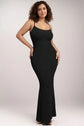 Woman in black sleeveless shapewear maxi dress for a sleek silhouette.